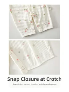 Detail of baby cotton romper showing convenient snap buttons and floral bunny pattern