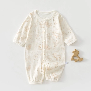Detail of baby romper featuring forest animal prints and snap button closure for easy dressing