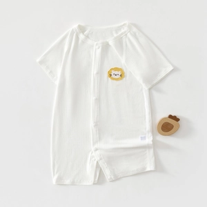 Detail of baby white ribbed cotton romper with a bright yellow cartoon lion patch