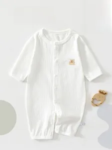 Close-up of white waffle texture baby romper with a cute 3D cartoon bear embroidery