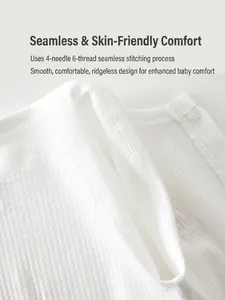 Soft white cotton baby romper featuring waffle texture and flat-lock stitching seams