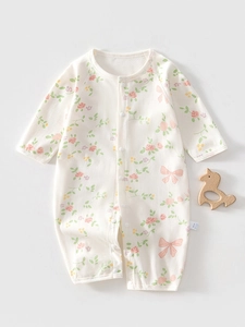 Detail of baby cotton floral romper showing breathable mesh fabric and snap button closure