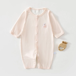 Detail of pink cotton baby romper with breathable mesh back and swan embroidery