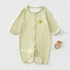 Close-up of soft green baby romper with yellow smile print and convenient snap buttons