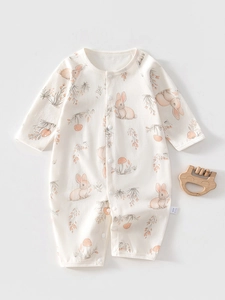 Detail of baby cotton long sleeve romper featuring cute rabbit and mushroom prints