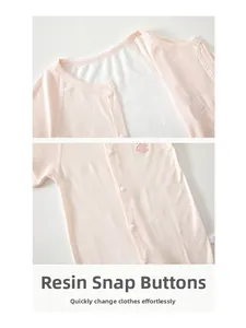 Close-up of pink ribbed baby romper featuring convenient resin snap buttons on the front