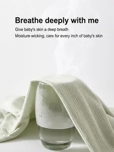 Breathable light green ribbed cotton baby romper fabric showing steam ventilation