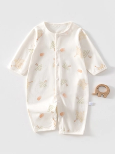 Close-up of baby romper with cute bear print and functional snap buttons on soft cotton