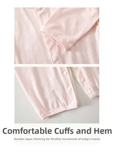 Close-up of pink baby onesie featuring secure resin snap buttons and durable stitched cuffs