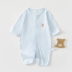 Detail view of baby blue romper with waffle texture knit and cute bear patch