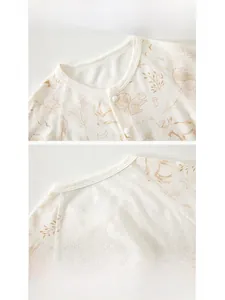 Close-up of breathable mesh cotton baby bodysuit with hand-drawn forest animal prints
