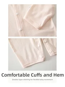 Detail of pink cotton baby romper showing snap buttons and fine double-stitched cuffs