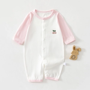 Close-up of baby waffle romper with cherry embroidery and soft cotton texture
