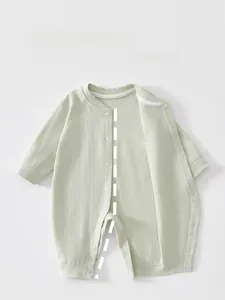 Detailed view of light green ribbed cotton baby romper with front snap button closure