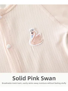 Close-up of pink baby bodysuit with swan embroidery and breathable mesh back detail