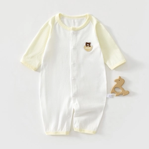 Detail of baby waffle knit romper featuring bear embroidery and soft pastel trims