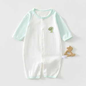 Detailed view of baby romper featuring breathable waffle texture and dinosaur embroidery