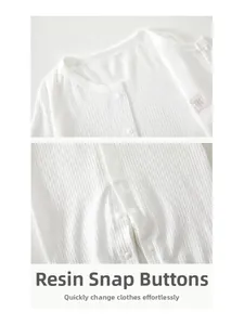 Detail of white waffle cotton baby romper with secure resin snap buttons and round neck