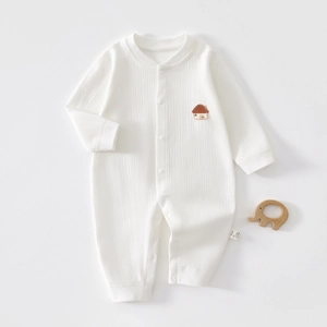 Detail of white rib-knit baby romper with house patch and button closure 100% cotton