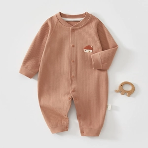 Detail of ribbed knit baby bodysuit with house embroidery and secure snap buttons