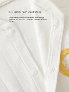 Detail view of baby romper featuring eco-friendly POM resin snap buttons and ribbed cotton fabric