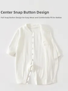 Detail of baby romper with center snap buttons and soft ribbed texture in white color