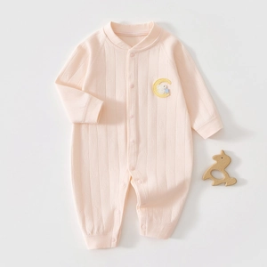 Close-up of pink cotton baby bodysuit featuring rabbit embroidery and ribbed texture