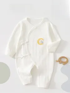 Close-up of soft ribbed cotton newborn bodysuit featuring moon and rabbit embroidery