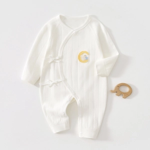 Detail of newborn cotton romper featuring side ribbons and moon bunny embroidery