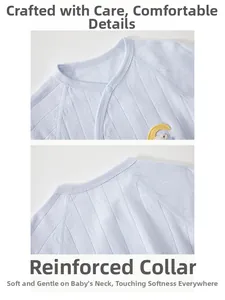 Detail of baby bodysuit featuring breathable cotton fabric with moon embroidery and snaps