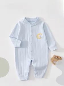 Detail of light blue cotton baby bodysuit featuring vertical knit and cute bunny embroidery