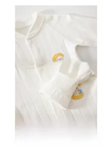 Detail of smooth seams and crescent moon embroidery on newborn cotton bodysuit