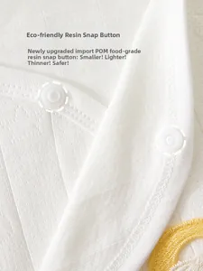 Detail of high-quality POM resin snap buttons on striped cotton newborn bodysuit fabric