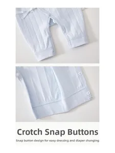 Detail of light blue baby romper showing knit texture and snap closure for diaper changes