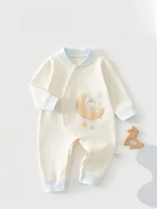 Detailed view of cream cotton baby romper with cute bear on moon and blue trim accents