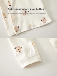 Detail of infant cotton sleepwear showing side snap buttons and cute bear print