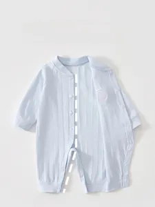Detail of baby light blue ribbed cotton romper with front snaps for easy dressing