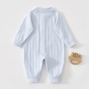 Detail of light blue infant romper showing breathable jacquard stripe texture and soft cotton fabric