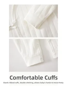 Detail of newborn cotton bodysuit showing ribbed cuffs and high-quality snap buttons
