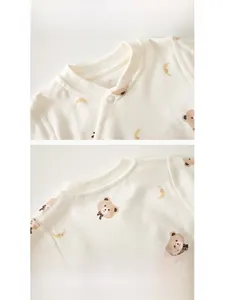 Close-up of baby ribbed neckline with snap buttons and moon bear prints on soft cotton