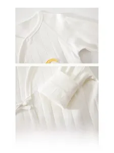 Detailed close-up showing the seamless flat-lock stitching on white ribbed cotton baby bodysuit