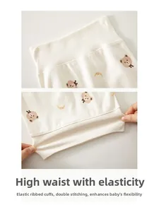 Detail of high waist baby pants showing elastic ribbed waist and cute bear print