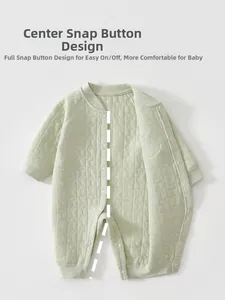 Close-up of quilted baby romper with moon and star pattern and snap buttons