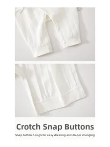 Detail view of crotch snaps on newborn white ribbed cotton romper for easy diaper changes