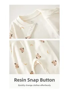 Detail of high-quality resin snaps and delicate cotton fabric on infant romper set