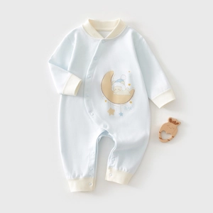 Detail of baby romper featuring snap button closure and cute bear on moon print
