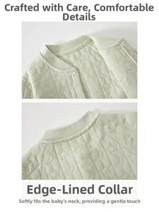 Detail of baby winter romper showing star quilted fabric and soft hemmed neckline