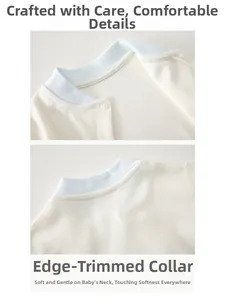 Detail of the bound round neckline on newborn cotton romper with resin button