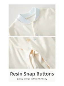 Detailed view of the soft cotton fabric and durable resin snaps on the baby romper