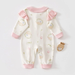 Detailed view of baby romper featuring ruffled shoulders and cute bunny floral prints